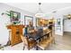Dining area with industrial-style table, wooden bench, and a view into the modern kitchen at 750 4Th Avenue South # 601H, St Petersburg, FL 33701