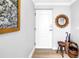 Bright entryway with white paneled door, wooden floors, decorative mirror, and hall tree at 750 4Th Avenue South # 601H, St Petersburg, FL 33701