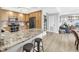 Kitchen offering stone counters, stainless appliances, and access to living area at 750 4Th Avenue South # 601H, St Petersburg, FL 33701