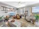 Cozy living room with ladder decor, a white ceiling fan, and comfortable leather armchairs at 750 4Th Avenue South # 601H, St Petersburg, FL 33701