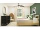Bright bedroom featuring two twin beds, ceiling fan, and stylish decor, creating a cozy and inviting space at 7770 Painted Sky Pl, Land O Lakes, FL 34637