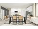 Open concept dining room with modern table and chairs, seamlessly connecting to the kitchen area at 7770 Painted Sky Pl, Land O Lakes, FL 34637