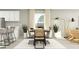 Bright dining area with modern decor, featuring a stylish table, chairs, and contemporary lighting at 7770 Painted Sky Pl, Land O Lakes, FL 34637
