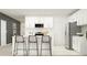 Bright modern kitchen featuring white cabinets, stainless steel appliances, and a functional breakfast bar at 7770 Painted Sky Pl, Land O Lakes, FL 34637