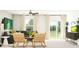 Bright living room featuring stylish furniture, neutral tones, and a sliding glass door to the outside at 7770 Painted Sky Pl, Land O Lakes, FL 34637