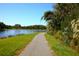 Picturesque walking path winding along the lake's edge, offering beautiful water and nature views at 7770 Painted Sky Pl, Land O Lakes, FL 34637