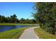 Scenic walking path along the water, providing residents with a tranquil route for exercise and relaxation at 7770 Painted Sky Pl, Land O Lakes, FL 34637
