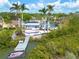 Aerial view showcasing backyard deck and dock in waterfront community at 7906 Bayshore Dr, Seminole, FL 33776