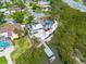 Beautiful waterfront home with lush landscaping, private dock, and canal access at 7906 Bayshore Dr, Seminole, FL 33776