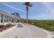 Spacious outdoor deck with stairs and seating, complemented by lush, tropical foliage at 7906 Bayshore Dr, Seminole, FL 33776