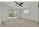 Bright bedroom featuring sliding glass doors leading to outdoor patio at 7906 Bayshore Dr, Seminole, FL 33776