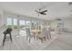 Bright dining room with water views, modern ceiling fan and seating for six at 7906 Bayshore Dr, Seminole, FL 33776