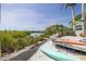 Outdoor deck with lounge area overlooking serene waterway and lush foliage at 7906 Bayshore Dr, Seminole, FL 33776