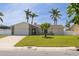 Attractive single-story home with well-maintained lawn, complemented by mature palms at 7906 Bayshore Dr, Seminole, FL 33776