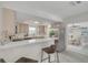 Kitchen with stainless steel appliances, breakfast bar, and a view into the dining room at 7906 Bayshore Dr, Seminole, FL 33776
