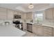 Well-lit kitchen featuring stainless steel appliances, sleek countertops and tile backsplash at 7906 Bayshore Dr, Seminole, FL 33776