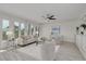 Sun-drenched living room with neutral decor, stylish seating, built-in cabinets, and large windows offering serene views at 7906 Bayshore Dr, Seminole, FL 33776