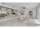 Open-concept floorplan showcasing the living and dining room with a modern color palette at 7906 Bayshore Dr, Seminole, FL 33776