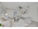 Bright, open living room with neutral tones, comfortable seating, elegant decor, and large windows for natural light at 7906 Bayshore Dr, Seminole, FL 33776