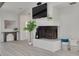 Bright living room featuring a cozy fireplace, stylish accents, and modern furnishings on top of beautiful floors at 7906 Bayshore Dr, Seminole, FL 33776