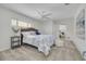Spacious main bedroom with a ceiling fan, soft carpet, and natural light at 7906 Bayshore Dr, Seminole, FL 33776