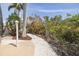 Landscaped walkway featuring stone, mulch, and tropical foliage at 7906 Bayshore Dr, Seminole, FL 33776