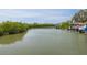 Picturesque waterfront view featuring boats docked along the tranquil canal at 7906 Bayshore Dr, Seminole, FL 33776