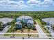 Aerial view of a stunning two-story home with lush landscaping and manicured grounds at 814 Manns Harbor Dr, Apollo Beach, FL 33572