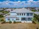 Aerial view of the home's backyard showing a patio and a large green lawn at 814 Manns Harbor Dr, Apollo Beach, FL 33572