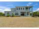 A two-story home featuring a spacious backyard and a second-story balcony at 814 Manns Harbor Dr, Apollo Beach, FL 33572