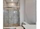 Modern bathroom featuring tiled shower, glass door, and pebble floor at 814 Manns Harbor Dr, Apollo Beach, FL 33572