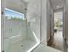 Bathroom shower with glass door and marble surround, view to the Main Bedroom at 814 Manns Harbor Dr, Apollo Beach, FL 33572