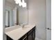 Bathroom vanity with dark wood cabinets, light countertop and bright lighting, offering style and functionality at 814 Manns Harbor Dr, Apollo Beach, FL 33572