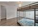 Bedroom with bunk beds, modern light fixture, and wood-look floors at 814 Manns Harbor Dr, Apollo Beach, FL 33572