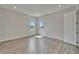 Bright bedroom with modern flooring, two windows, and neutral paint at 814 Manns Harbor Dr, Apollo Beach, FL 33572