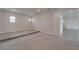 Carpeted bonus room with step-up platform and natural lighting at 814 Manns Harbor Dr, Apollo Beach, FL 33572
