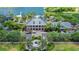 An aerial view of a grand clubhouse with palm trees, a fountain, and well-maintained landscaping at 814 Manns Harbor Dr, Apollo Beach, FL 33572
