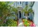 Elegant home entrance with stone accents and vibrant landscaping, creating a welcoming curb appeal at 814 Manns Harbor Dr, Apollo Beach, FL 33572