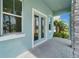 Inviting outdoor space with tiled floors, stone accents, and stylish blue-trimmed doors and windows at 814 Manns Harbor Dr, Apollo Beach, FL 33572