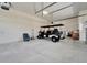 Spacious garage featuring high ceilings with a golf cart and plenty of room for storage at 814 Manns Harbor Dr, Apollo Beach, FL 33572