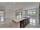 Open kitchen with large island, pendant lights, tile floors and outside view at 814 Manns Harbor Dr, Apollo Beach, FL 33572