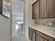 View through butler's pantry into kitchen and breakfast area at 814 Manns Harbor Dr, Apollo Beach, FL 33572