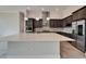 Kitchen island featuring quartz countertops, modern fixtures, and ample cabinet space at 814 Manns Harbor Dr, Apollo Beach, FL 33572