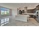 Modern kitchen with a large island, pendant lighting, and stainless steel appliances at 814 Manns Harbor Dr, Apollo Beach, FL 33572