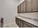 Functional laundry room with ample counter space and modern cabinetry at 814 Manns Harbor Dr, Apollo Beach, FL 33572