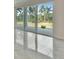 Bright living room with large sliding glass doors and sleek tile flooring at 814 Manns Harbor Dr, Apollo Beach, FL 33572