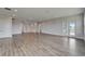 Open living area features sleek wood floors and access to outdoor balcony at 814 Manns Harbor Dr, Apollo Beach, FL 33572