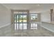 Open living area with marble floors, recessed lighting, and sliding glass doors for natural light at 814 Manns Harbor Dr, Apollo Beach, FL 33572