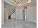 Open-concept living area with stairs, marble floors, and modern lighting at 814 Manns Harbor Dr, Apollo Beach, FL 33572