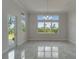Bright living room featuring large windows and luxurious marble floors at 814 Manns Harbor Dr, Apollo Beach, FL 33572